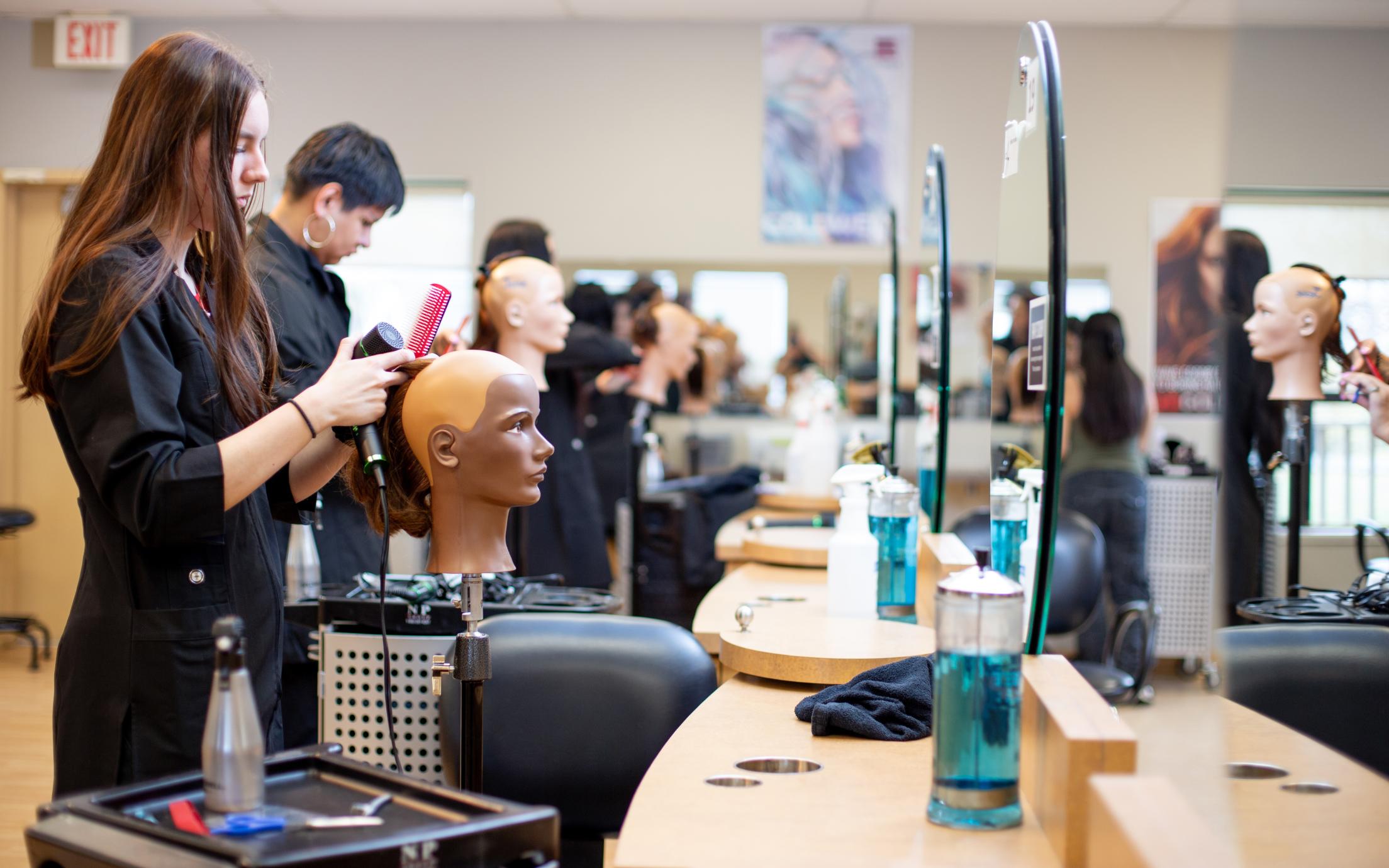 VIU hairstylist students cut mannequins hair