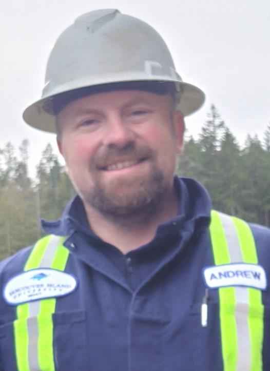 Andrew Coles, HEO Instructor, wearing a hard hat and VIU high visibility coveralls