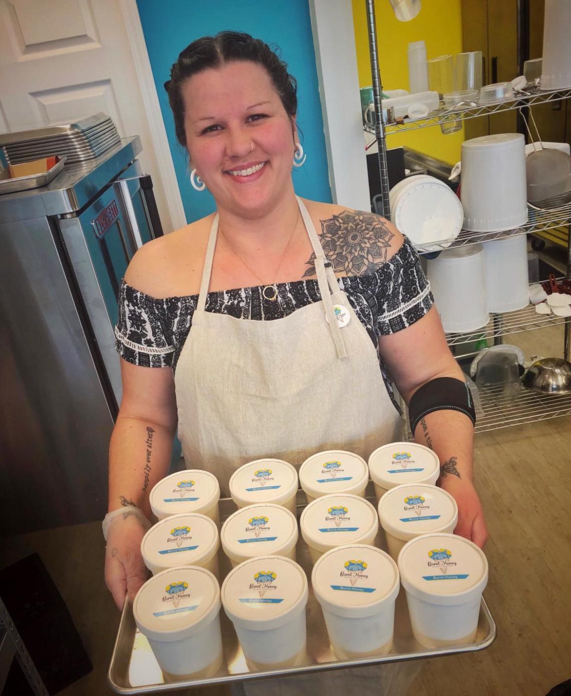 Baking and Pastry Arts student holding a tray of ice cream in containers