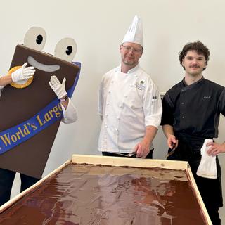 Nani the Nanaimo bar mascot poses with chefs and the world's largest Nanaimo bar
