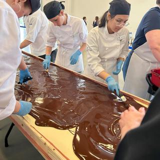 VIU baking students apply the chocolate layer to the  world's largest Nanaimo bar