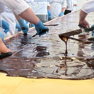 VIU baking students apply the chocolate layer to the  world's largest Nanaimo bar