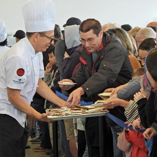 A VIU baking instructor serves Nanaimo bars to the community
