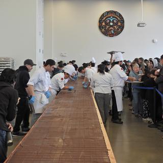 The full length of the Nanaimo bar with student bakers and event attendees