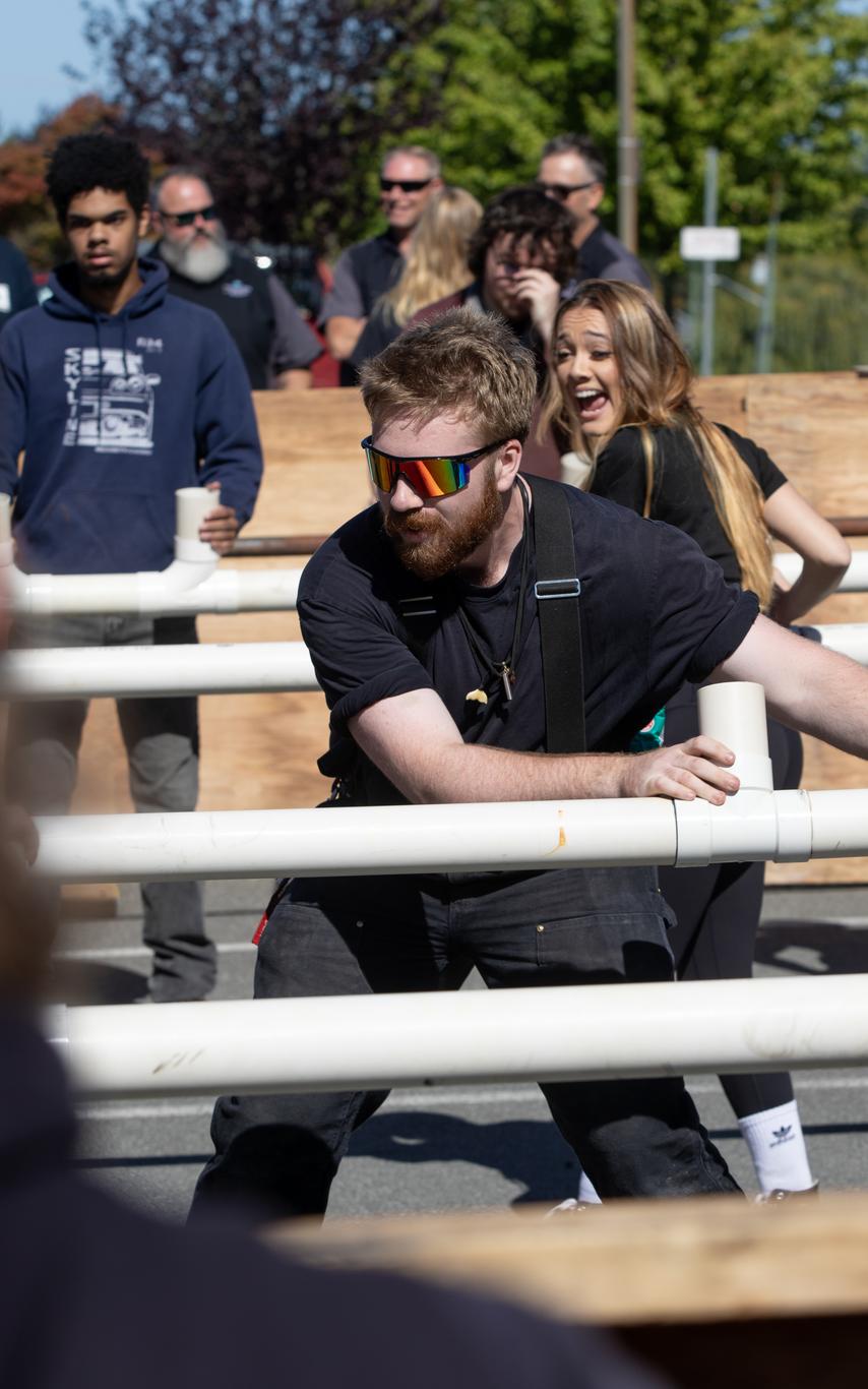 students playing human sized foosball